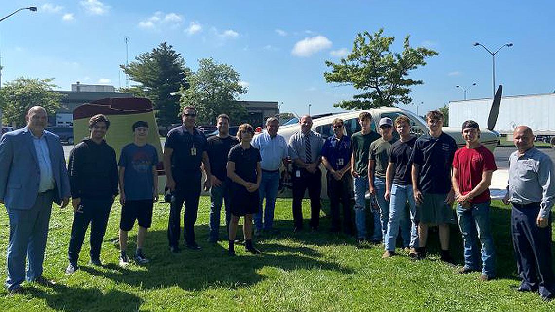 From left are John Zehentbauer, Mahoning County Career and Technical Center superintendent; Christian Cosa, a 2021 graduate of MCCTC’s Aviation Maintenance program; Samuel Rosenberger of West Branch; David Williams, owner and pilot of the plane; Mario Berardi of Boardman; Bryce Keck of West Branch; Mike Stanko, MCCTC board president; Matt Campbell, MCCTC principal; Scott Rowe, aviation instructor; Connor Brothers of Springfield; James Groom of West Branch; Peyton Quarles of Austintown Fitch; Trenton Kirchner of Austintown Fitch; Devin Andrews of Austintown Fitch; and Brian Rella, MCCTC treasurer. (Contributed photo)