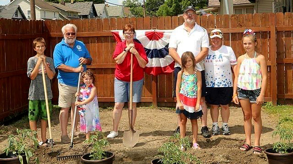 Nathan Keener; John P. Brown II, AMVETS Post 44 commander; Katie Ann Vanditti; Jan Brown, AMVETS national commander; Gary Powell; Nancy Powell; Ava Disantis; and Mya Disantis helped plant a “Victory Garden” at the AMVETS Post 44 facility. (Photo by Frank Marr)