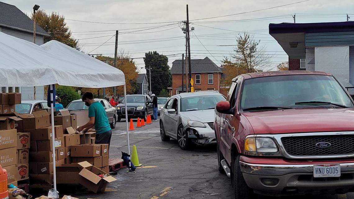 Two lines of cars wait for food assistance at the All People’s Fresh Market in Columbus.