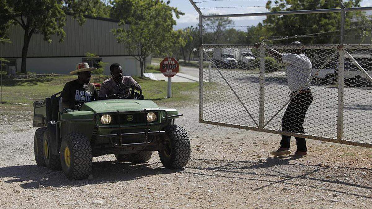 Workers ride out of the gate of the Christian Aid Ministries headquarters in Titanyen, north of Port-au-Prince, Haiti, on Dec. 6, 2021.