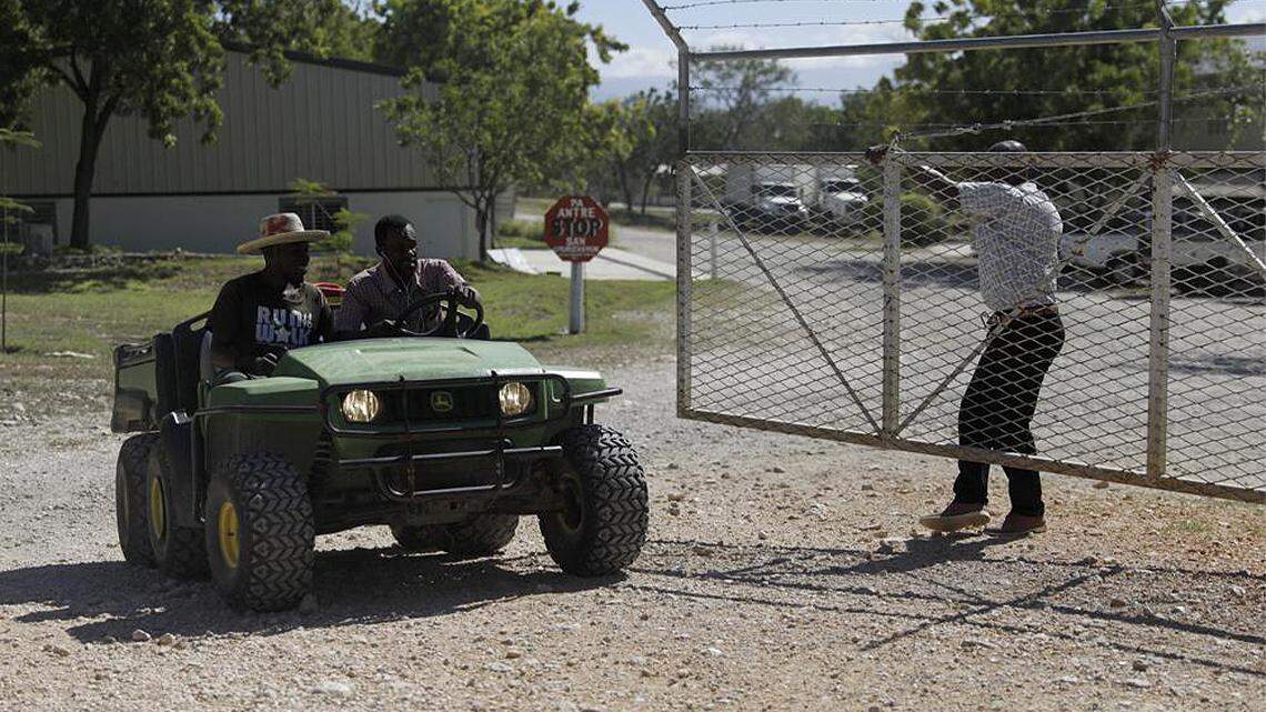 Workers ride out of the gate of the Christian Aid Ministries headquarters in Titanyen, north of Port-au-Prince, Haiti, on Dec. 6, 2021.