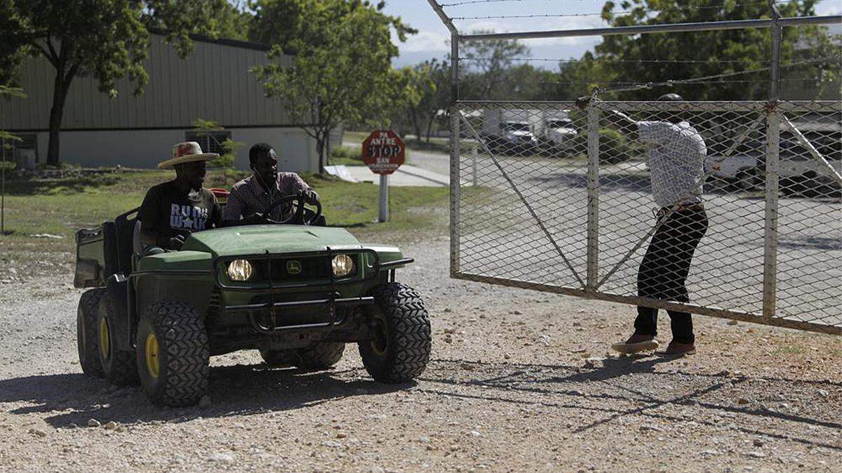 Workers ride out of the gate of the Christian Aid Ministries headquarters in Titanyen, north of Port-au-Prince, Haiti, on Dec. 6, 2021.