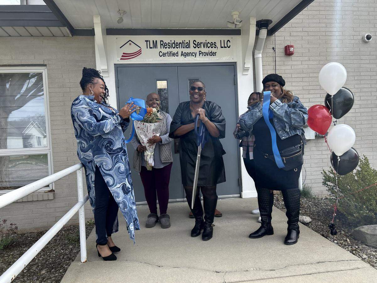 Owner Toni Mitchell cut the ribbon at TLM Residential Services to celebrate the new adult day program in Austintown.