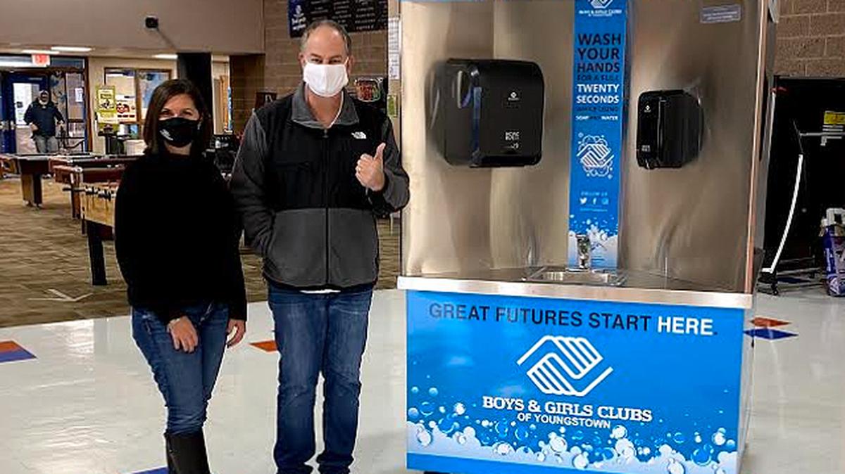 Wanda Wellman, development director of the Boys & Girls Clubs of Youngstown, and Jeff Swartz, owner of Personal Protected, stand next to the Quad-Sink hand-washing station that was delivered to the Boys & Girls Clubs of Youngstown on Wednesday. (Contributed photo)