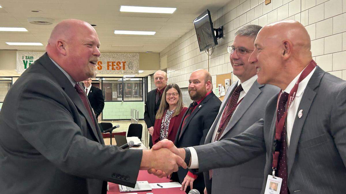 New superintendent Chris Neifer, Board President John Fryda and Tim Saxton, current superintendent who is retiring at the end of July.