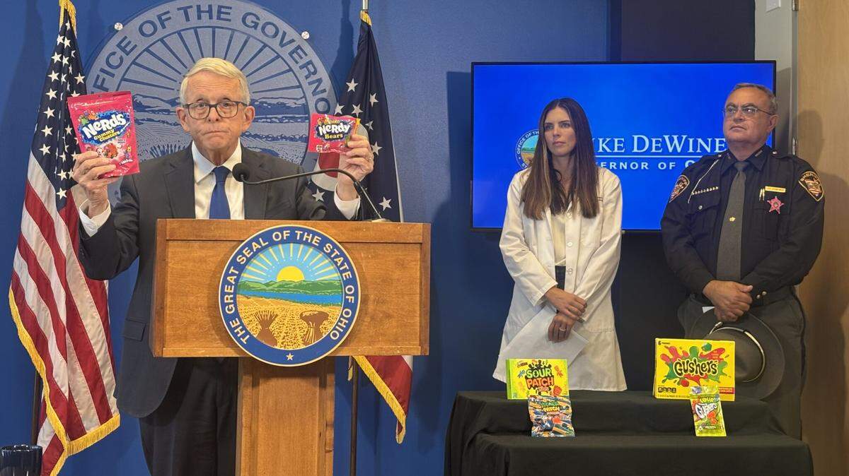 Ohio Gov. Mike DeWine holds up intoxicating hemp product Nerdy Bears and Nerds Gummy Clusters during a press conference where he issued an executive order banning intoxicating hemp products.
