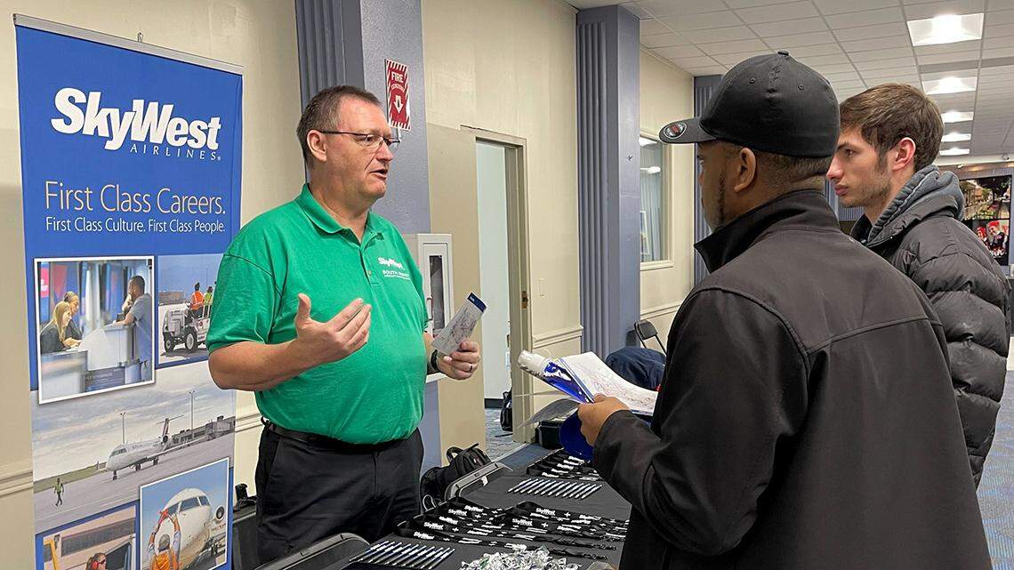 Douglas McCartney, a representative of SkyWest Airlines (left) talks with Pittsburgh Aeronautical Institute students during a career fair Thursday at the institute’s campus at the Youngstown-Warren Regional Airport in Vienna Township.