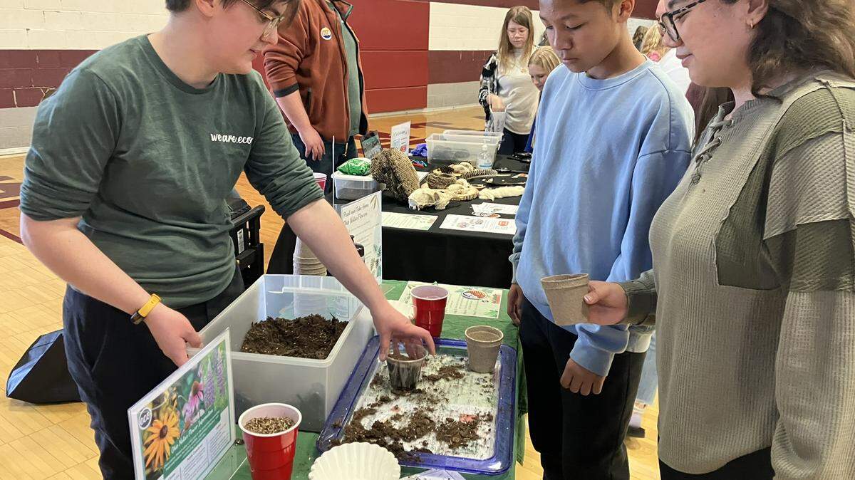 Jenna Johnston, left, of Boardman, shows off her wildflower pots during the Boardman STEAM event at Glenwood Junior High School.