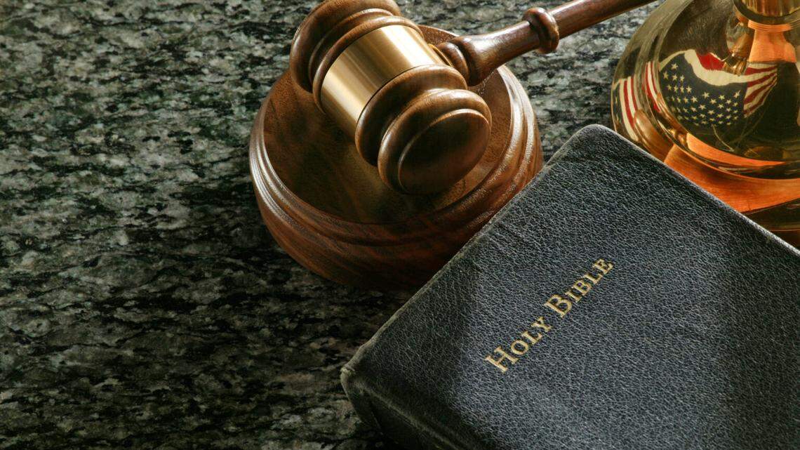 “Close up of gavel, bible,and scale of justice on marble surface. Reflection of American flag in scale of justice.For more legal images click here:”