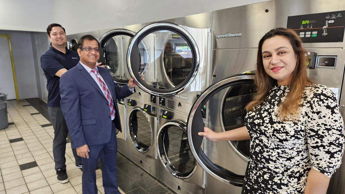 Owner Tajul Islam celebrating opening his new washer and dryer facility in Boardman.