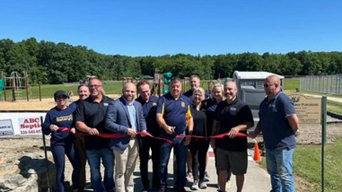 Local and state officials and members of the Rotary Club host a ribbon cutting ceremony for the Austintown Township Park expansion