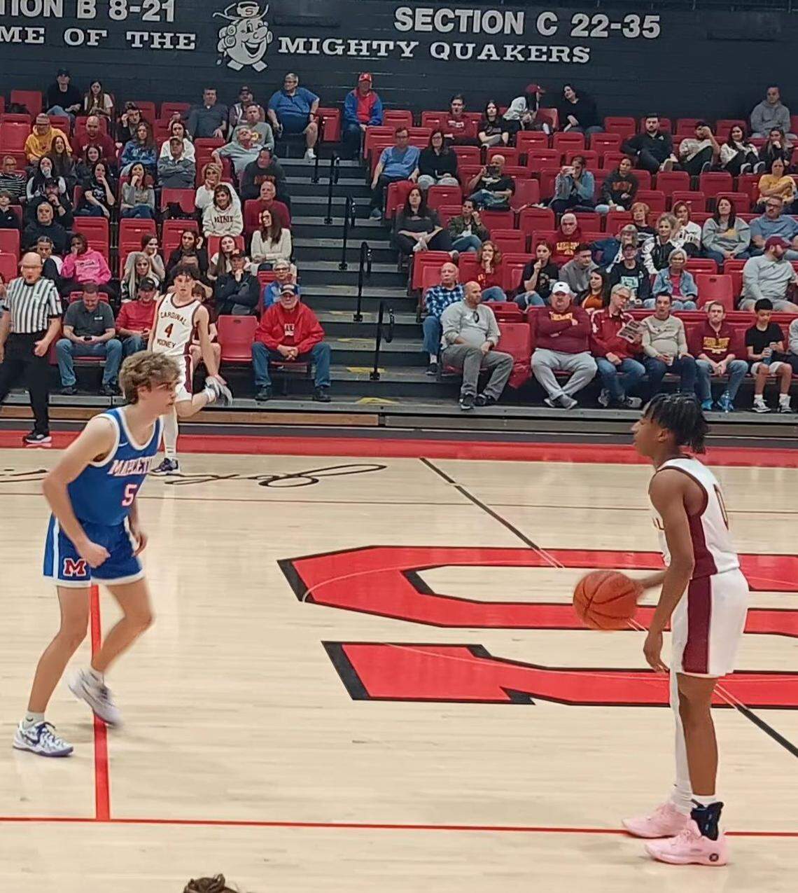 Youngstown Cardinal Mooney’s Jibri Carter, right, looks inside to pass the ball as Mapleton’s Kyle Sloter (5) defends during Monday night’s Division 3 district semifinal boys’ basketball tournament game in Salem’s John A. Cabas Gymnasium.