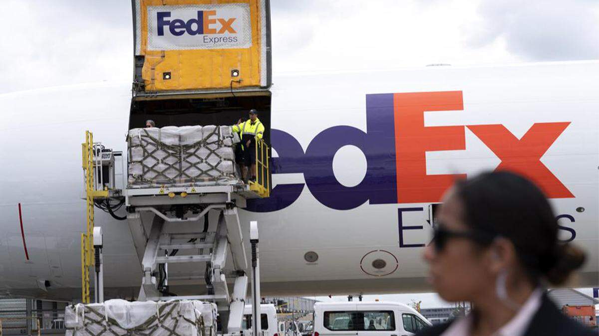 Workers unload a Fedex Express cargo plane carrying 100,000 pounds of baby formula at Washington Dulles International Airport in Chantilly, Va., on May 25.