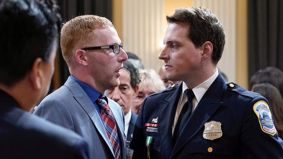 Stephen Ayres, who pleaded guilty in June 2022 to disorderly and disruptive conduct in a restricted building, shakes hands with Washington Metropolitan Police Department officer Daniel Hodges as the hearing with the House select committee investigating the Jan. 6 attack on the U.S. Capitol, concludes at the Capitol in Washington, Tuesday, July 12, 2022.