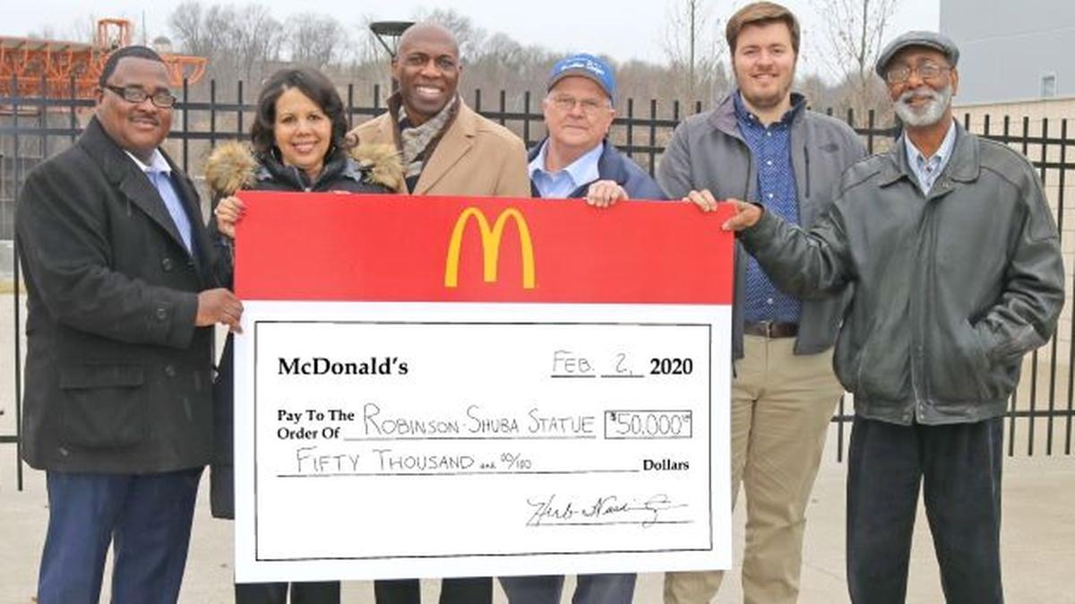 Standing near the Youngstown Amphitheatre, site for the proposed Robinson-Shuba Commemorative Statue, are, from left, Guy Birney, Susan Moorer and Herb Washington, representing local McDonald’s restaurants, and Greg Gulas, Nick Chretien and Ernie Brown from the statue project committee. (Contributed photo)