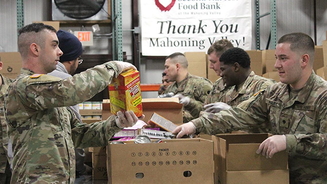 Twenty men and women in Ohio's National Guard help sort emergency boxes filled with food Monday at the Second Harvest Food Bank of the Mahoning Valley. They were deployed to assist with food distribution in the area for the next month. (Photo by Justin Dennis | Mahoning Matters)