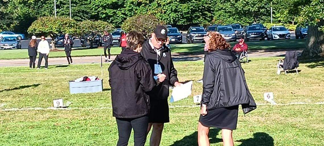 Race officials go over details before the start of a race at Saturday’s Boardman Spartan Cross Country Invitational.