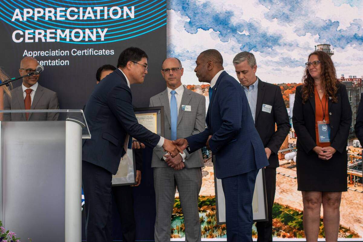 Logan Choi, president and CEO of Trumbull Energy Center, greets Warren Mayor Doug Franklin during the Trumbull Energy Center Project Completion Ceremony on Wednesday at the facility in Lordstown.