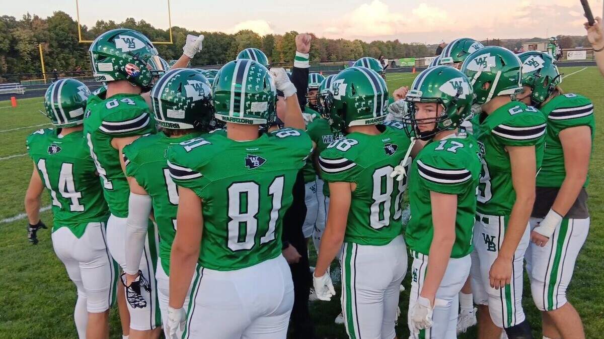 West Branch players meet with a position coach before their game against Alliance Friday night in Beloit.