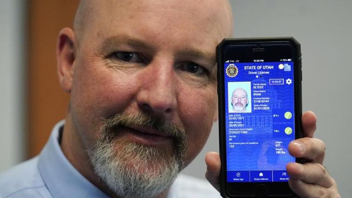 Ryan Williams, with the Utah Drivers License Division, displays his cellphone with the pilot version of the state’s mobile ID on May 5 in West Valley City, Utah. The card that millions of people use to prove their identity to everyone from police officers to liquor store owners may soon be a thing of the past as a growing number of states develop digital driver’s licenses. (Rick Bowmer | AP Photo)