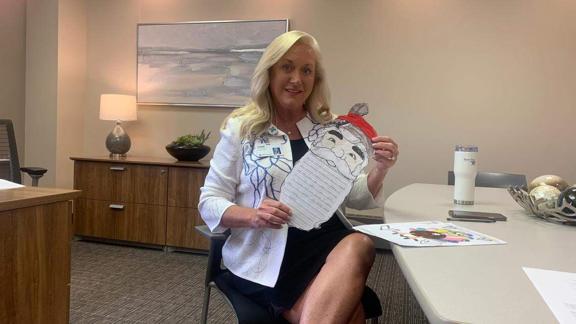 Charlotte Gardiner, president of St. Joseph Warren Hospital shows letters she’s received from her pen pal, Naveah.