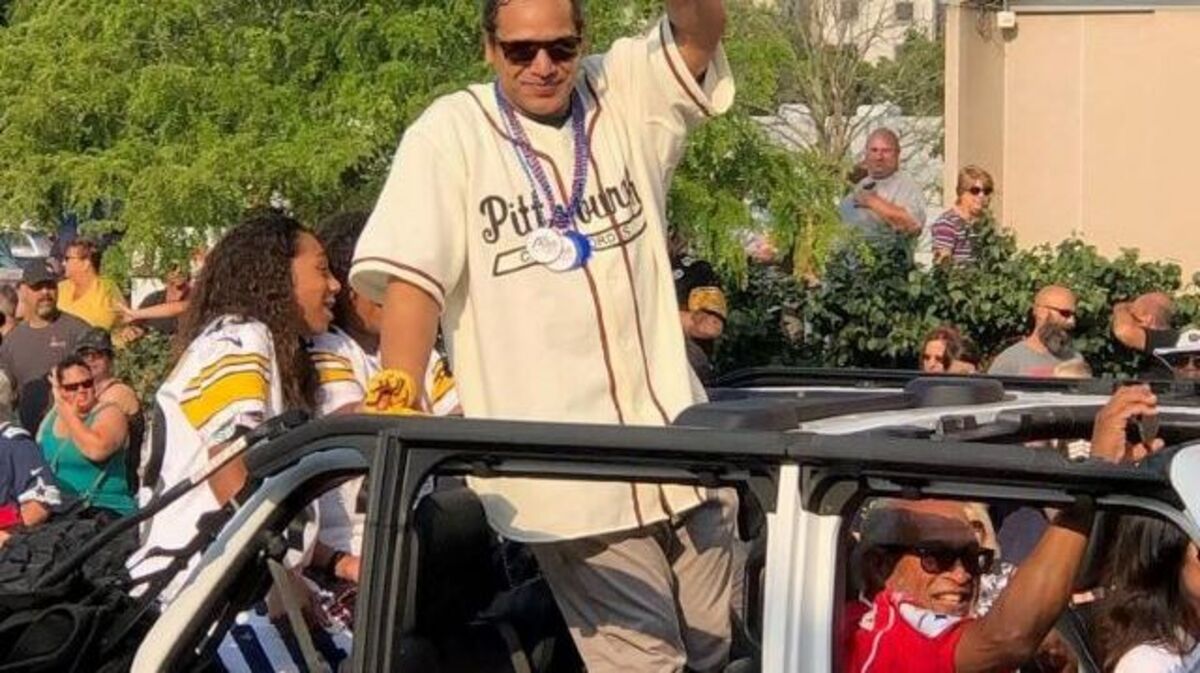 Former Pittsburgh Steelers star safety Troy Polamalu waves to fans and supporters today in Canton along the route of the 2021 Canton Repository Grand Parade. Polamalu has recovered from a bout with COVID-19 and will attend tonight's Pro Football Hall of Fame inductions. Polamalu, a member of the class of 2020, has been at home since late last month and his status for the enshrinement ceremony had been in doubt. But he was cleared medically to travel to Canton and he took part in the Hall of Fame parade in the morning. (Anne Desrosiers via AP)