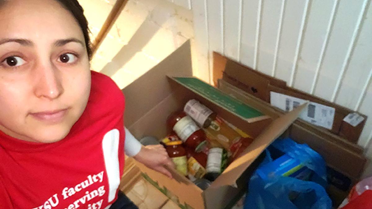 Alicia Prieto Langarica, an associate professor at Youngstown State University, shows some of the items collected for the university's food pantry for students who are remaining on campus during the COVID-19. (Photo provided)