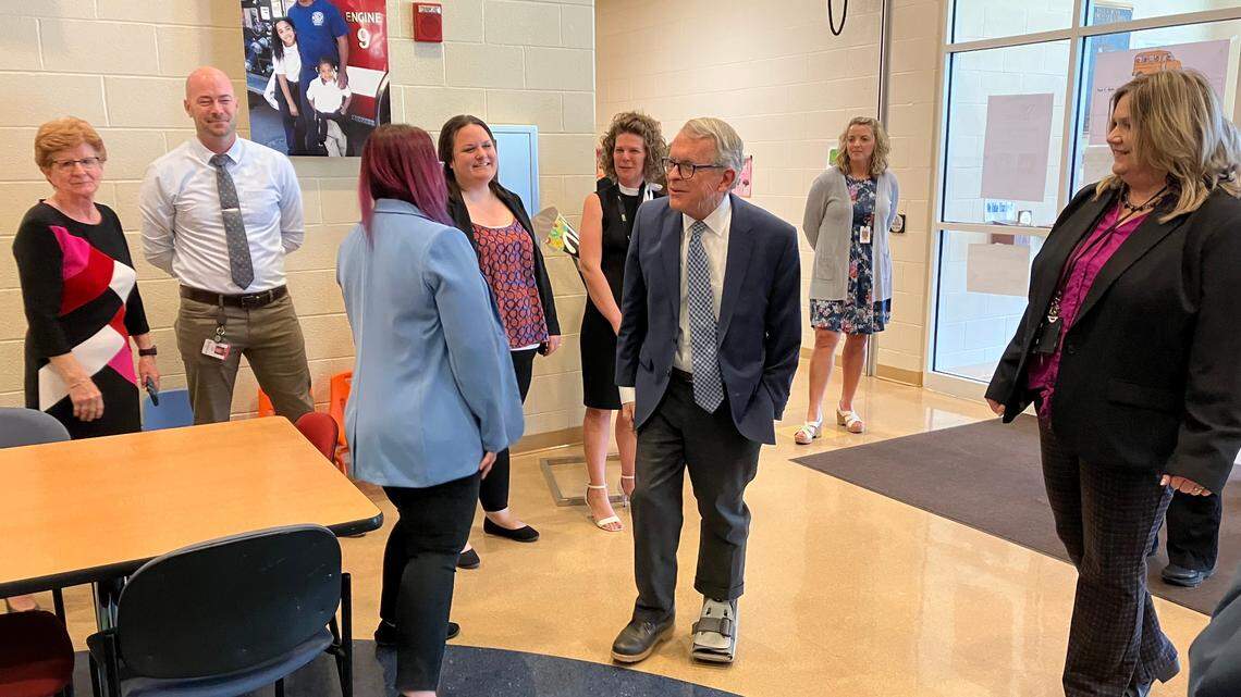 Ohio Gov. Mike DeWine greets staff members Thursday as he arrived for an appearance at Paul C. Bunn Elementary School.