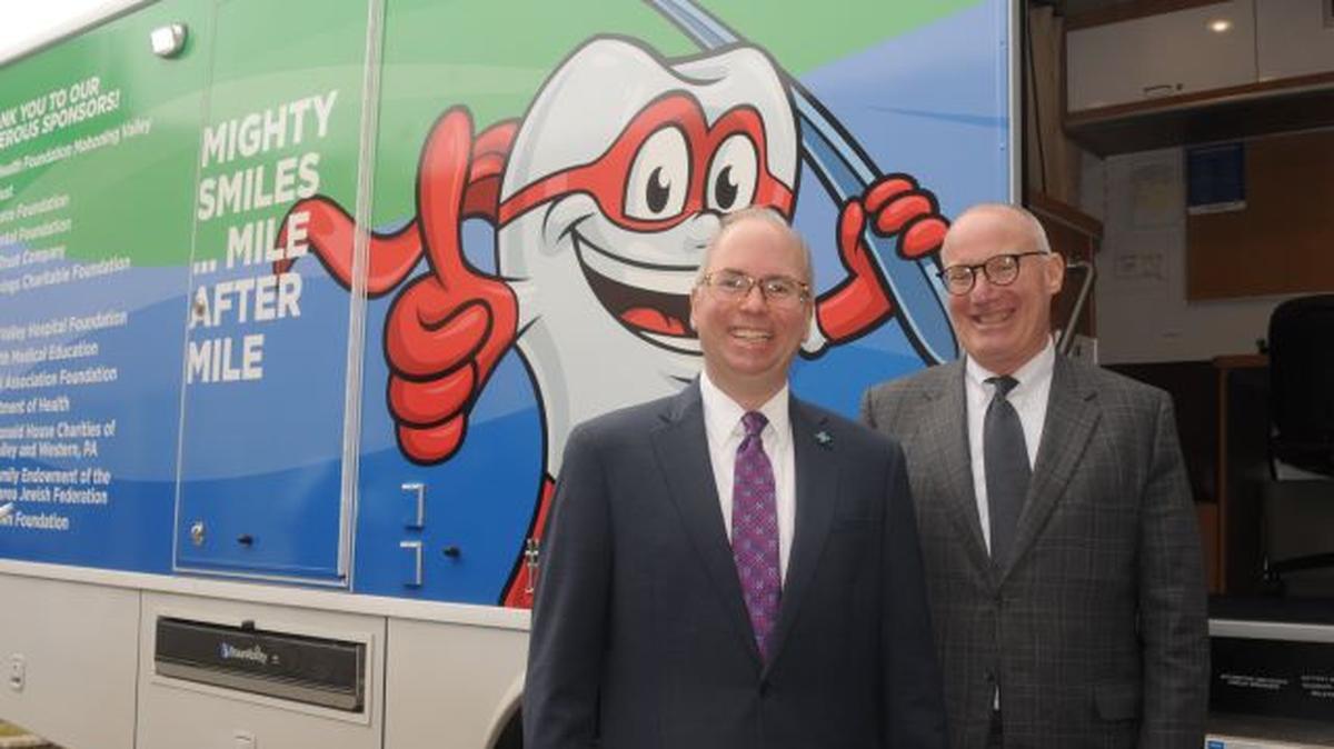 Paul Homick, president of Mercy Health Foundation Mahoning Valley, and M. Frank Beck, director of the St. Elizabeth Dental Clinic and residency programs, were among the first to tour the new $450,000 mobile dental clinic. (Contributed photo)