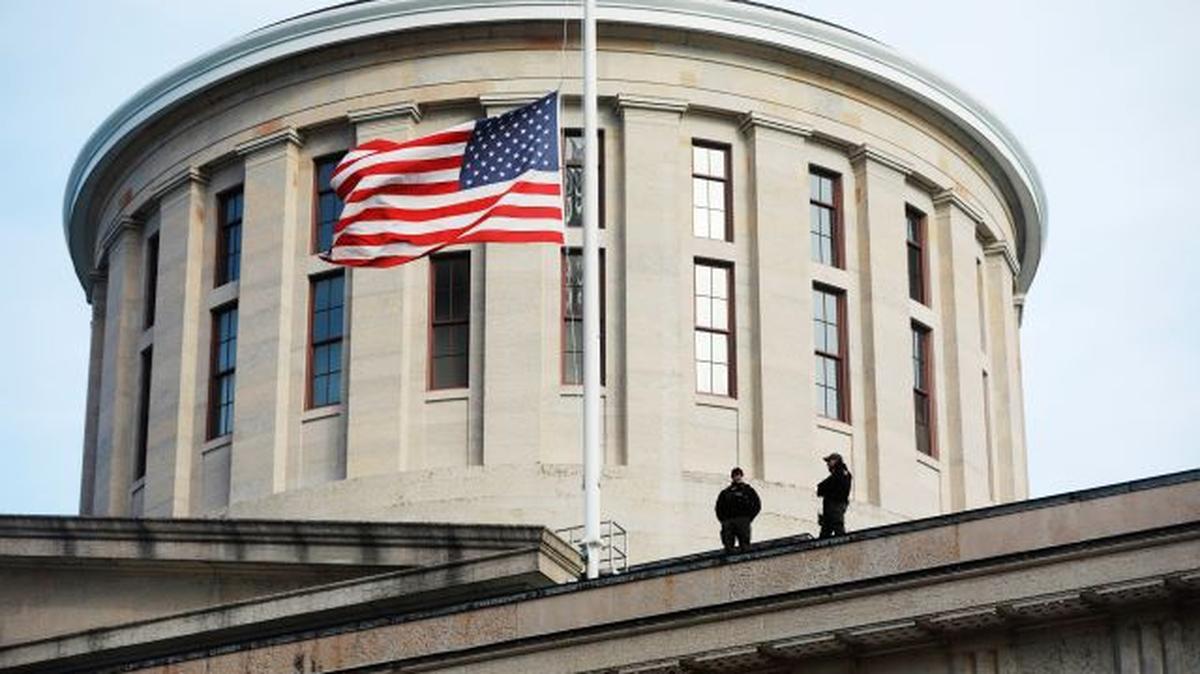FILE - In this Jan. 13, 2021 file photo, fwo Ohio State Highway Patrol troopers look out from the Ohio Statehouse roof in Columbus. Republican lawmakers in Ohio on Thursday, June 24, have moved to approve a bill banning transgender girls from participating in female sports teams in high school or college. The proposal, titled the Save Women’s Sports Act, would require schools and higher education institutions in the state to designate “separate single-sex teams and sports for each sex.” (Doral Chenoweth/The Columbus Dispatch via AP)