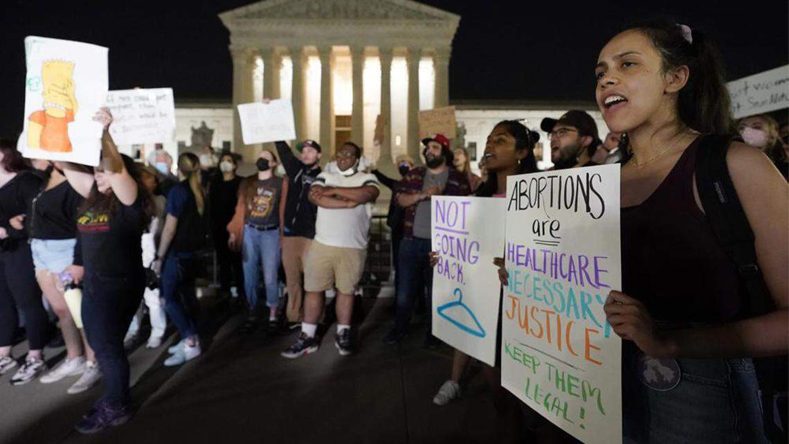 A crowd of people gather outside the Supreme Court in Washington early Tuesday. A draft opinion circulated among Supreme Court justices suggests that earlier this year a majority of them had thrown support behind overturning the 1973 Roe v. Wade case that legalized abortion nationwide, according to a report published Monday night in Politico. It’s unclear if the draft represents the court’s final word on the matter.