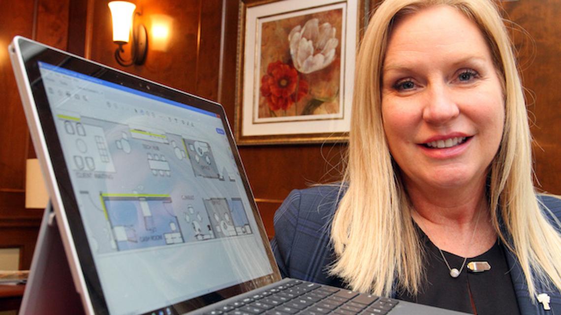 Amber Wallace, Farmers Bank chief retail and marketing officer, shows  plans for new branch lab Farmers is going to open soon. (William D. Lewis/Mahoning Matters)