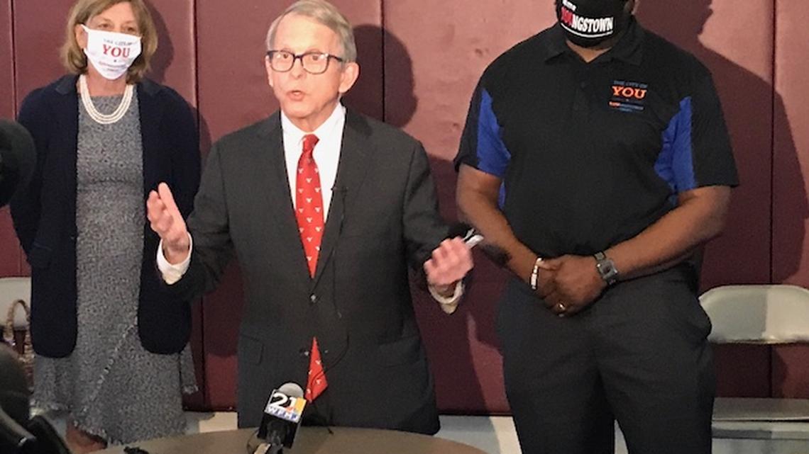 Gov. Mike DeWine is flanked by Youngstown city officials during his visit to Youngstown on Monday, March 22, 2021.