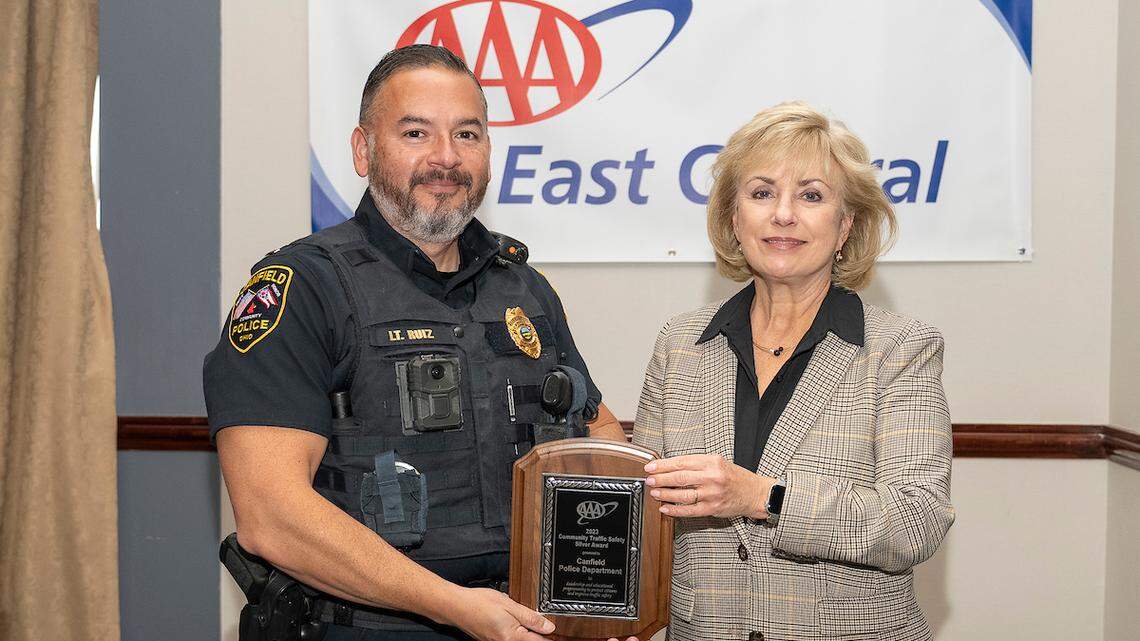 Cris Ruiz representing Canfield Police Department and accepting the silver award from AAA East Central.