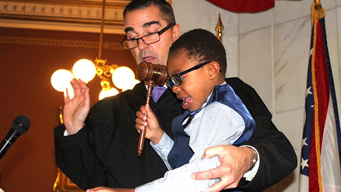 Mahoning County Probate Court Judge Robert Rusu, left, helps Nathan Cain, 5, drop the gavel formally finalizing his adoption to the Cain family of Troy during a ceremony Friday, Nov. 1, 2019 at the Mahoning County Courthouse.