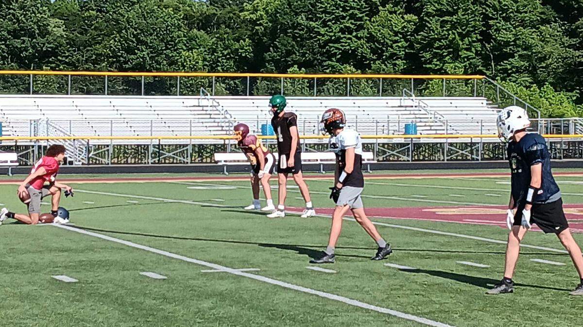 Ohio quarterback Beau Alazaus, third from right, prepares to take a shotgun snap during a Buckeyes’ practice session recently at South Range High School. Ohio will meet Pennysylvania in the 45th annual Stateline Football Classic Thursday night at 7 p.m. at Geneva College in Beaver Falls, Pa.