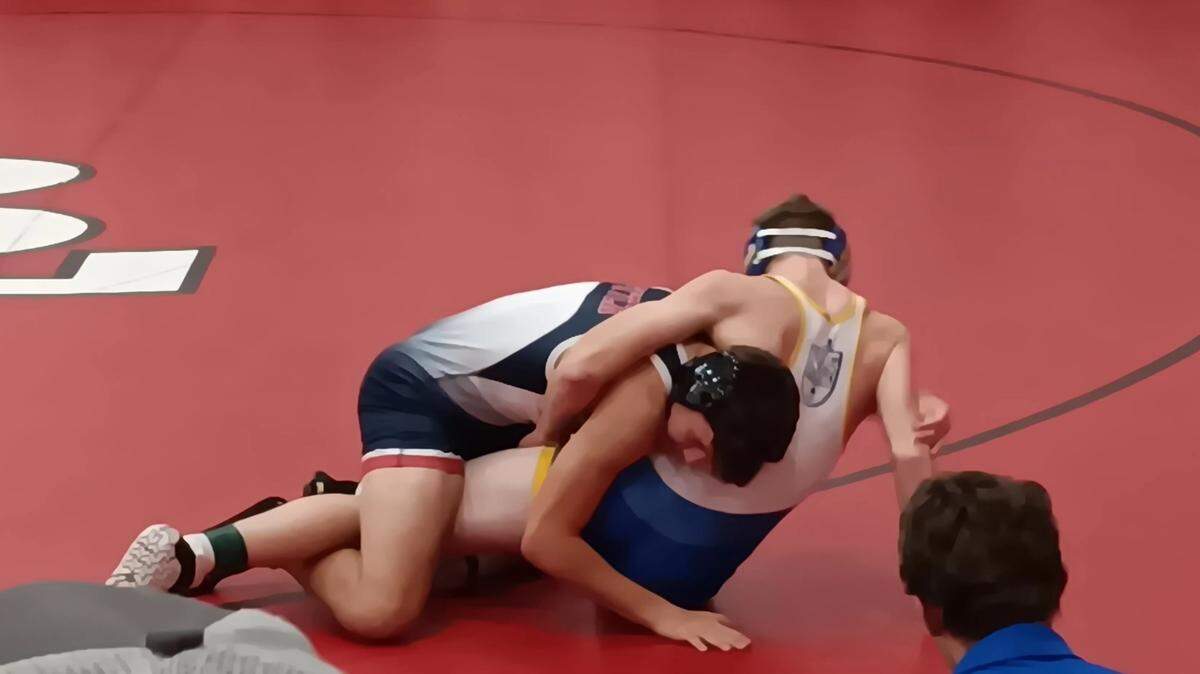 Austintown Fitch’s Dom Boano, left, prepares to pin Steubenville Catholic Central’s Miguel Jauregui in their 138-pound match during the 46th annual Everett Hoppel Memorial Wrestling Tournament Saturday at Beaver Local High School. Beano went on to place sixth in the Tournament. Photo/Mike Brown