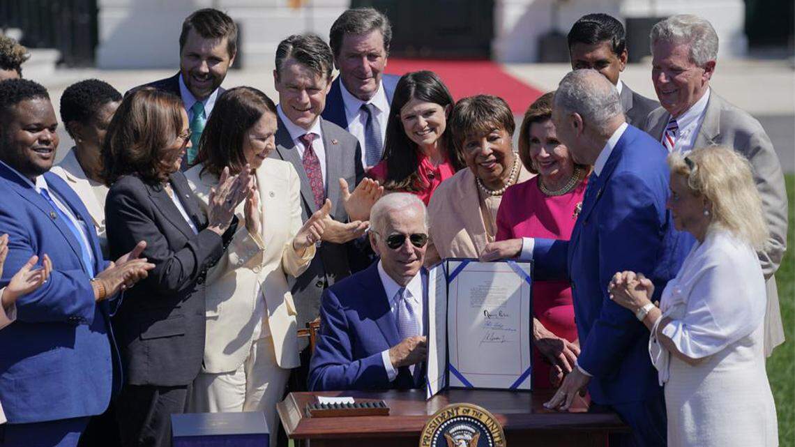 President Joe Biden holds the CHIPS and Science Act after signing it during a ceremony on the South Lawn of the White House in Washington on Aug. 9, 2022.