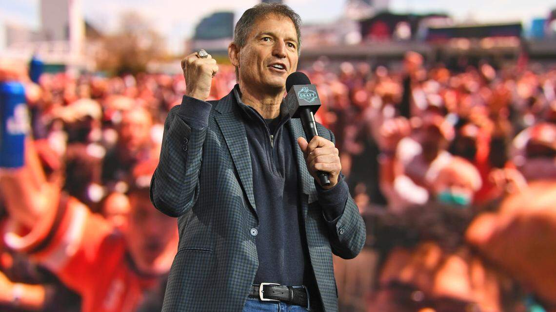 FILE - Former Cleveland Browns quarterback Bernie Kosar speaks to fans during the fourth round of the NFL football draft, May 1, 2021, in Cleveland. The Browns fired the beloved Kosar from their pregame radio broadcast before the season finale against Pittsburgh after he violated NFL policy by placing a wager earlier this week after sports gambling became legal in Ohio. (AP Photo/David Dermer, File)