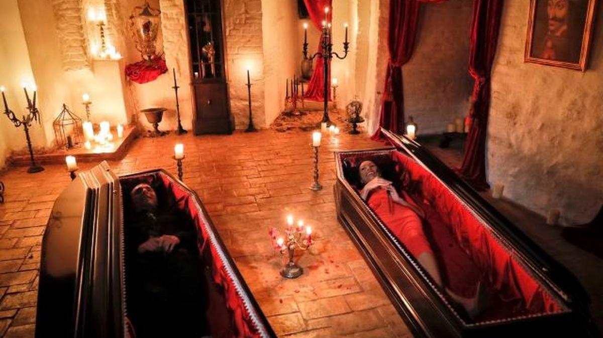 Tami Varma, right, and her brother, Robin, the grandchildren of Devendra Varma — a scholar of English gothic tales and an expert in vampire lore — pose in coffins at the Bran Castle in Bran, Romania, on Oct. 31, 2016. (Vadim Ghirda | AP)