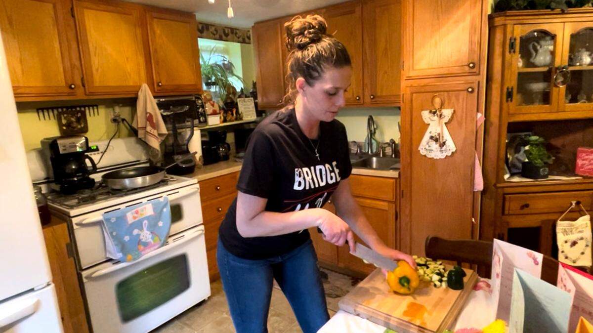 Mahoning County drug court participant Denise Raub, 32, prepares food in her Poland home on March 31, 2022.