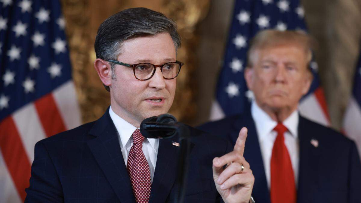 U.S. House Speaker Mike Johnson speaks as former President Donald Trump looks on at a press conference at Trump’s Mar-a-Lago club on April 12, 2024, in Palm Beach, Florida. Trump, who won November’s presidential election, endorsed Johnson to remain speaker Monday.