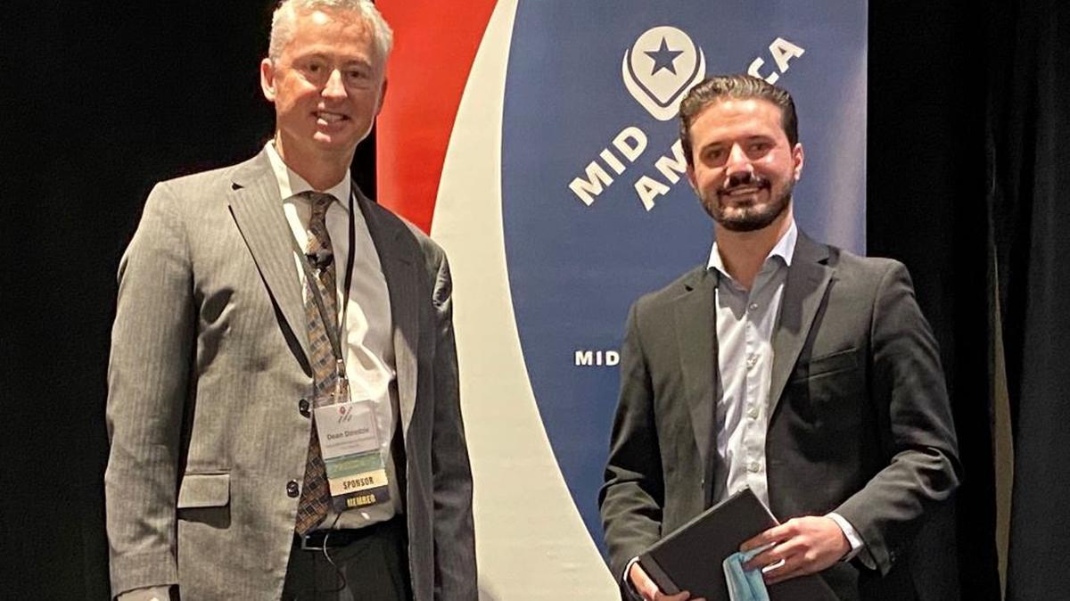 Shea MacMillan, right, the Youngstown/Warren Regional Chamber’s director of Economic Development Projects, attended the 2021 Mid-America Economic Development Council’s Competitiveness Conference in Chicago last week to accept the Economic Impact Deal of the Year Award. At left is Dean Dziedzic, Mid-America EDC board president. (Contributed photo)