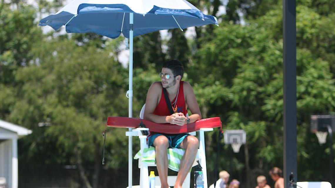 At the Jewish Community Center's Logan Campus swimming pool, lifeguard Randy McCloskey watches swimmers Tuesday during the fourth day of 90-plus degree weather. (Robert K. Yosay | Mahoning Matters)
