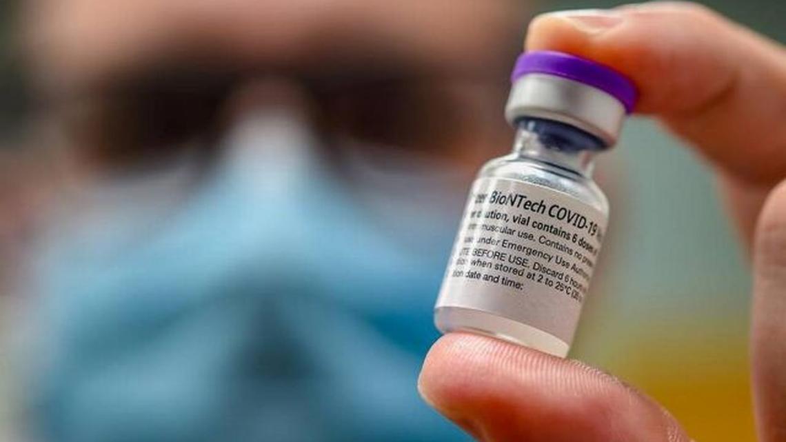 Dustin Guest, immunization coordinator for the Platte County Health Department, displays a dose of the Pfizer COVID-19 vaccine during a vaccination clinic in Parkville, Mo., on Aug. 5. (Tammy Ljungblad | tljungblad@kcstar.com)