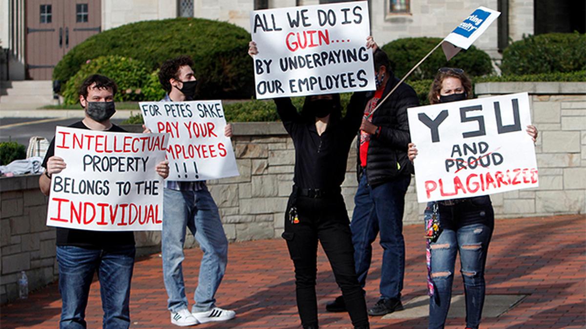 Students hold signs in front of the Butler Institute of American Art on Wick Avenue to show support for faculty members on Day 3 of the YSU-OEA strike Wednesday. (Photo by Robert K. Yosay | Mahoning Matters)