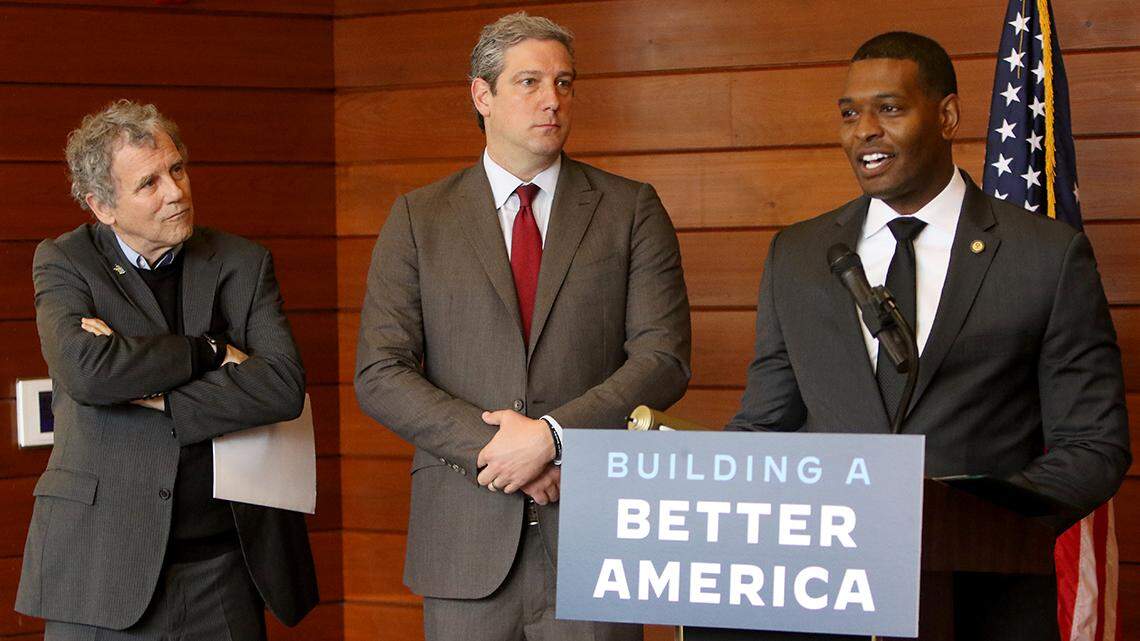 U.S. EPA Administrator Michael Regan (right) speaks with reporters on Tuesday, April 19, 2022, at the Michael Kusalaba Library along Mahoning Avenue in Youngstown, following a tour of homes along Eddie Street that are marked for lead pipe removal using federal infrastructure dollars. Alongside are U.S. Sen. Sherrod Brown of Cleveland, D-Ohio (left) and U.S. Rep. Tim Ryan of Howland, D-13th.