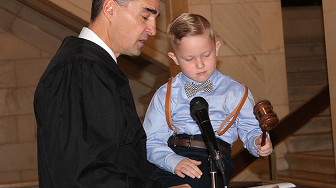 Mahoning County Probate Court Judge Robert Rusu, left, helps Jackson Gilmartin, 5, drop the gavel formally finalizing his adoption to the Gilmartin family of Austintown during a ceremony Friday, Nov. 1, 2019 at the Mahoning County Courthouse.