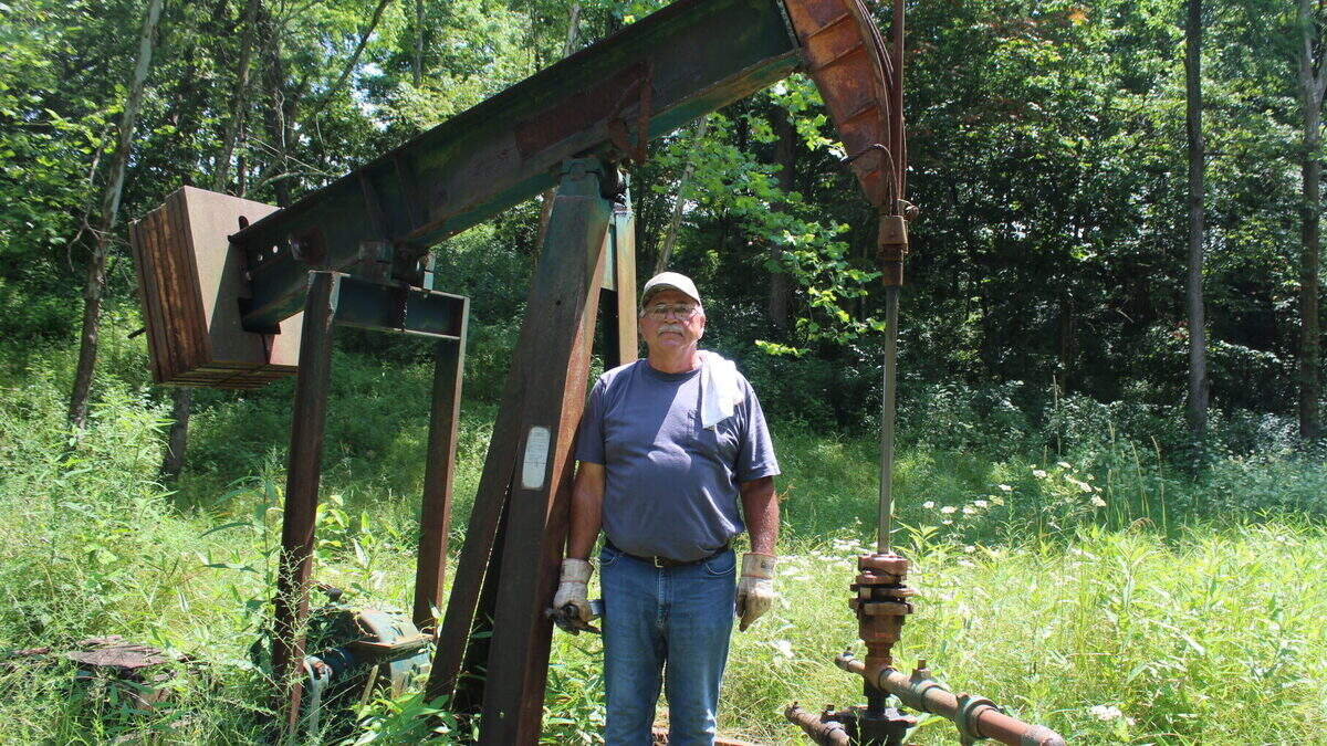 Bob Wilson, an oil producer in Washington County stands in front of one of his injection wells.