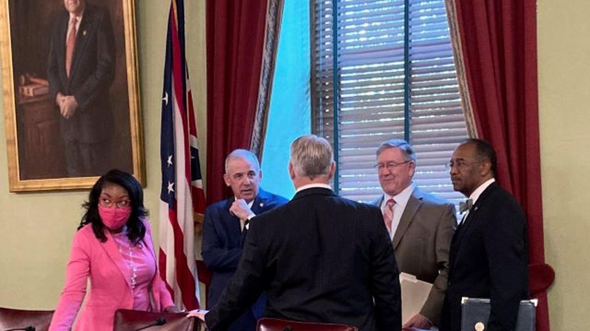 In this Aug. 6 file photo, from left, Ohio House Democratic Leader Emilia Sykes, Senate President Matt Huffman, House Speaker Bob Cupp, both Republicans, and Democratic state Sen. Vernon Sykes speak to Auditor Keith Faber at the Ohio Statehouse in Columbus ahead of the first meeting of the Ohio Redistricting Commission on which they all sit. (Julie Carr Smyth | AP Photo, File)
